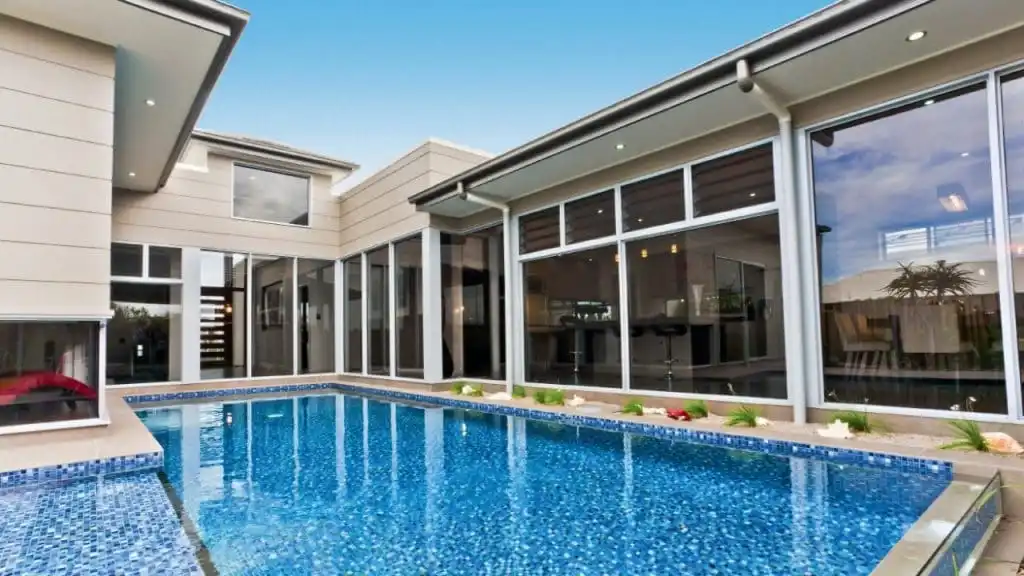 Blue pool outside of house — Doors & Windows in Armidale, NSW